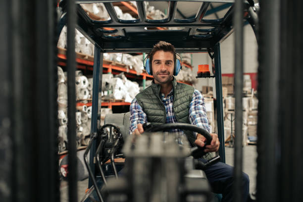 istock Smiling forklift driver working on the floor of a warehouse 2176719577