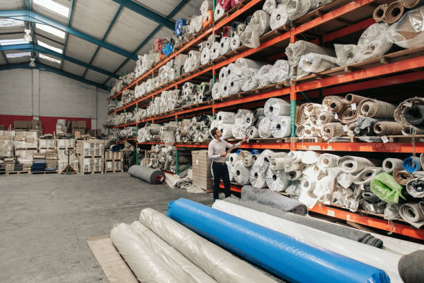 Interior of a industrial warehouse with fabric rolls.