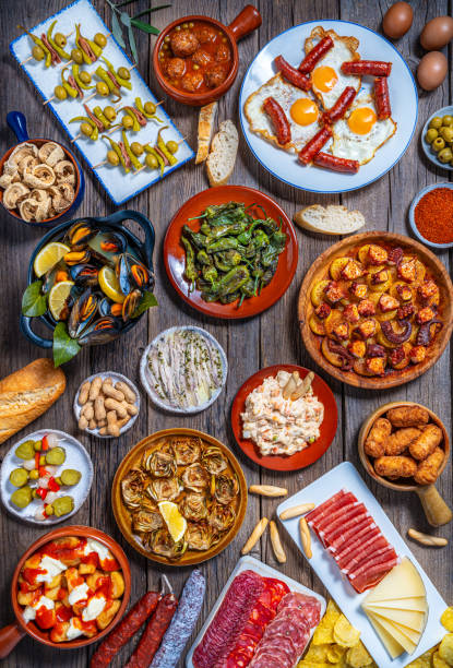 istock Assorted Spanish tapas and pintxos spread on a rustic wooden table 2176721692