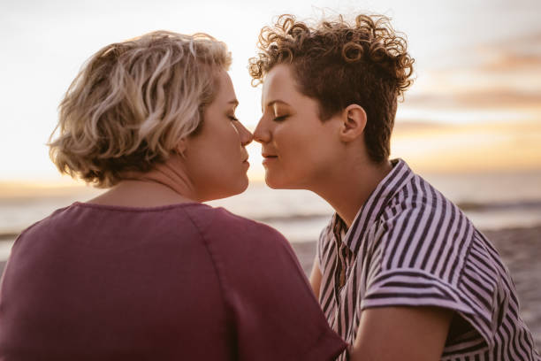 istock Affectionate young lesbian couple enjoying a romantic beach sunset together 2176723720