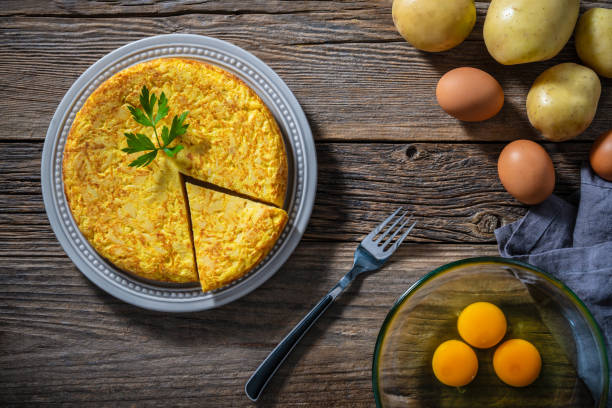 istock Traditional Spanish omelette with potatoes and onions on rustic wooden tabletop 2176723791