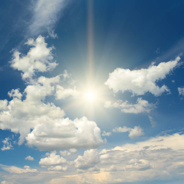 istock Sun on beautiful blue sky with white fluffy clouds. 2176727573