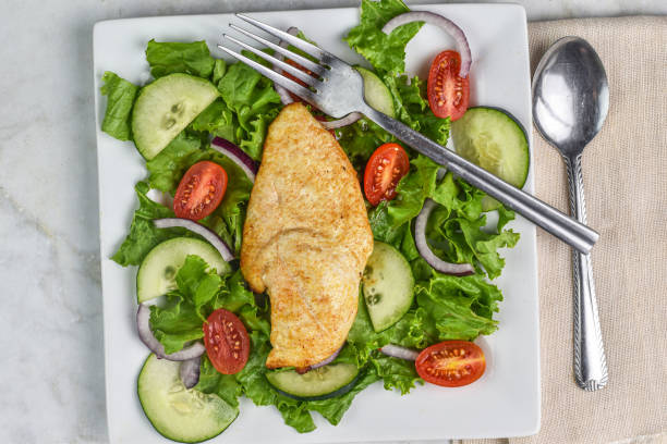 seasoned chicken  breast served with   a garden salad
