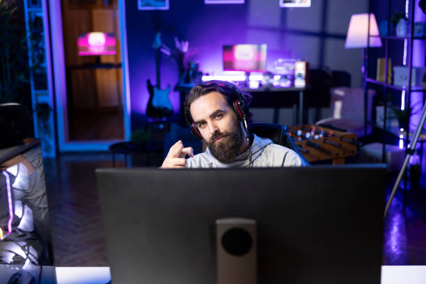 istock Man on gaming chair greeting viewers before playing videogame 2176729143