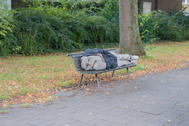 Homeless woman lying on the street.