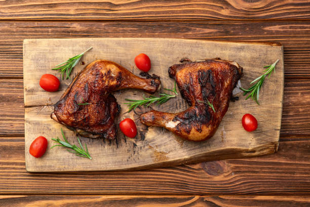 istock Grilled chicken legs with tomatoes and salad . Top view 2176732262