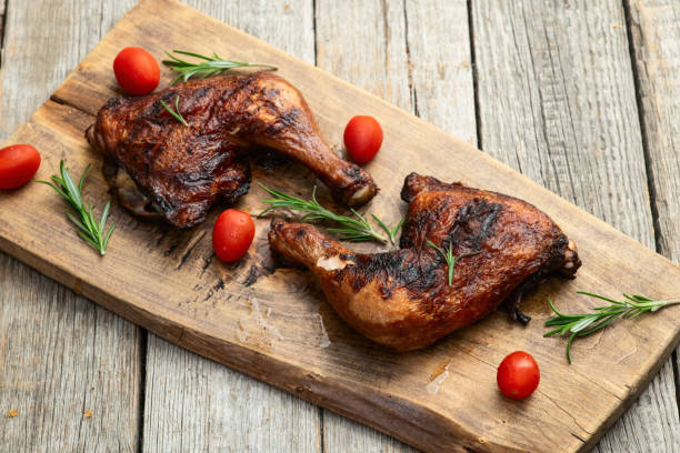 istock Grilled chicken legs with tomatoes and salad . Top view 2176732267