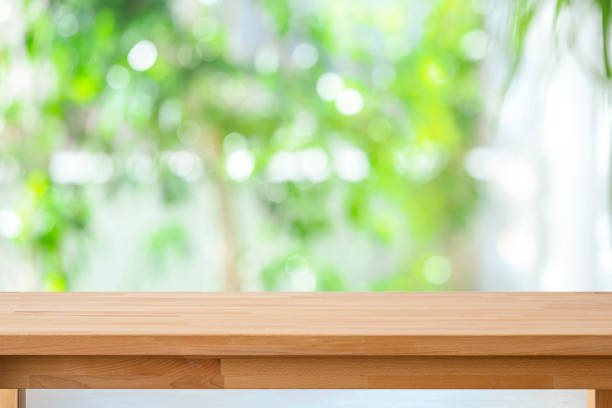 istock Empty table top with defocused green foliage at background 2176732330