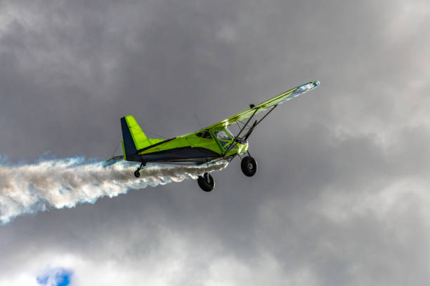 Riga, Latvia - November 18, 2024: Vintage airplanes at a military parade with colored smoke in the colors of the Latvian flag