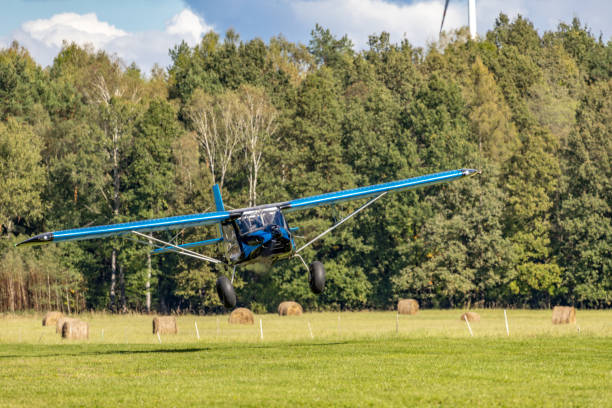 istock Ultralight planes flying low over a grassy airport 2176733784