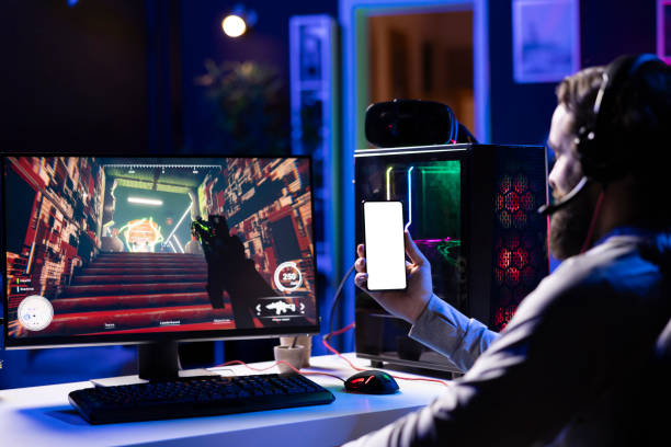 istock Man watching tutorial on how to finish videogame on mockup phone 2176735189