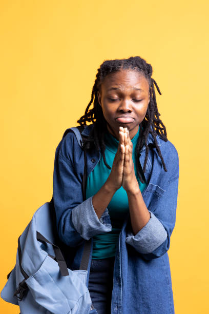 istock Religious girl doing worship gesturing, waiting for miracle, studio background 2176736106