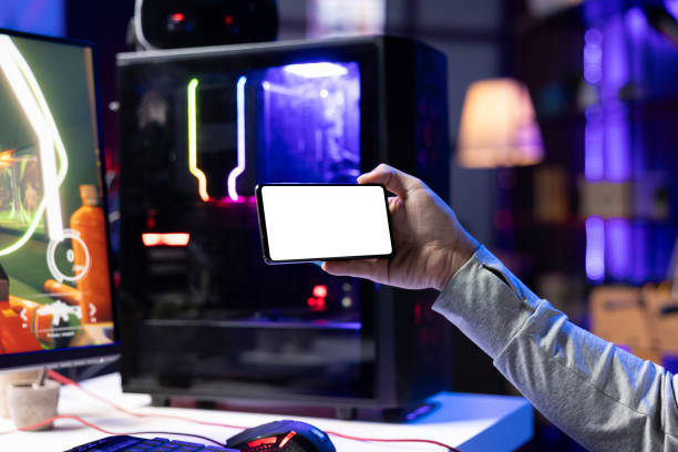 istock Gamer watching videos on isolated screen device, while at computer desk 2176738209