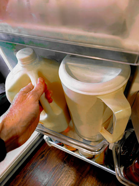 istock person taking milk out of refrigerator 2176748781