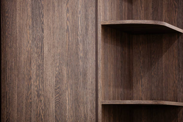 istock Dark wood bookshelf with empty shelves. 2176749314