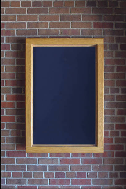istock dark gray framed sign on brick wall for advertisement or announcement 2176750518