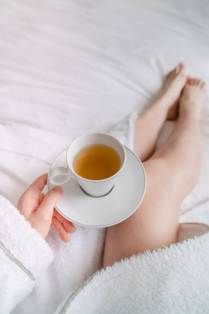 Herbal tea with flowers. Rosebay willow herb tea in a clear glass mug the beautiful morning light. Chamaenerion angustifolium or Fireweed herbal hot tea. Alternative medicine herb drink concept.