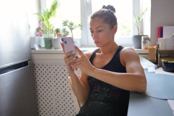istock A Young Woman is Engaged with Her Smartphone While in a Stylish Modern Kitchen Setting 2176753251