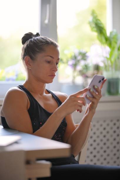 istock A Young Woman is Engaged with Her Smartphone While in a Stylish Modern Kitchen Setting 2176753258