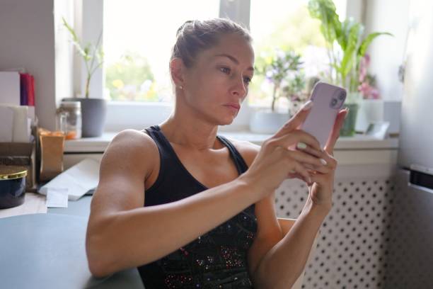 istock A Young Woman is Engaged with Her Smartphone While in a Stylish Modern Kitchen Setting 2176753261