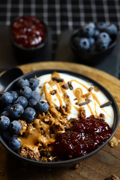 istock bowl with chocolate granola white yogurt peanut butter and raspberry jam 2176757492