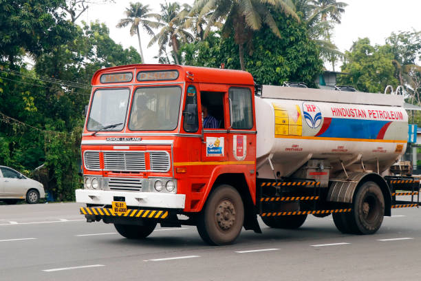 Colourful trucks at rest stop on rural road, Gujarat, India. Its in the rural villages and countryside of India that the true colours and character of the country are experienced. Gujarat, the north western state of India,  encompasses part of site of the Indus Valley civilisation, the oldest known to mankind and is also home to some of the most historic sites and religious locations in India. The Rann of Kutch is famous for its arid desert like landscapes as well as wildlife such as the Wild Ass, together with Gir Forest, home to the only Asiatic Lions in the continent.