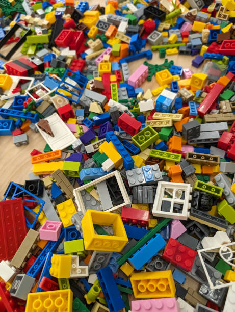 A vibrant collection of toy blocks is scattered on a table, showcasing a variety of colors and shapes, perfect for inspiring creativity in building projects.