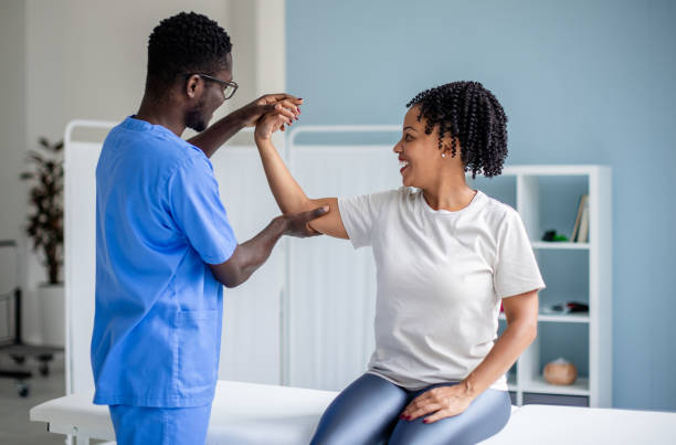 istock Therapist assisting patient with arm movement guidance 2176786603