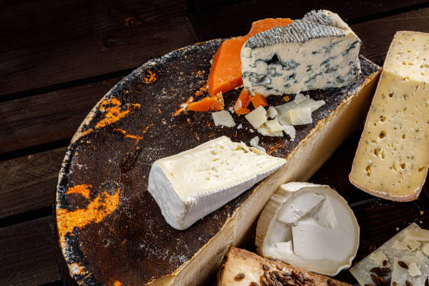 istock A Selection of Artisanal Cheeses Arranged Beautifully on a Rustic Serving Board for Sharing 2176797957
