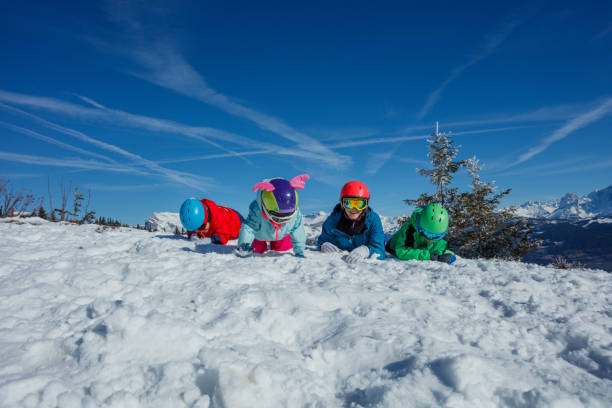 istock Family lying on snow, surrounded by majestic mountain scenery 2176798247