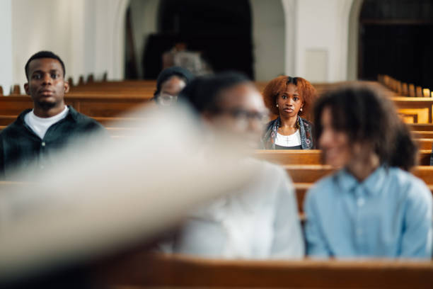 istock Young woman looking thoughtful during church service 2176799526