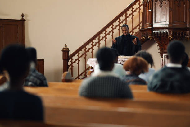 istock Young pastor preaching in front of congregation at church 2176799531