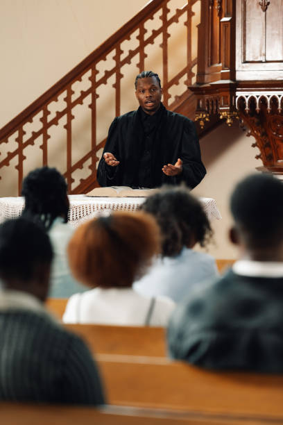 istock Young priest giving sermon from the pulpit to parishioners 2176799536