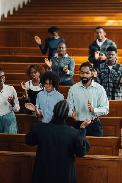 istock Congregation clapping and singing during gospel church service 2176799558