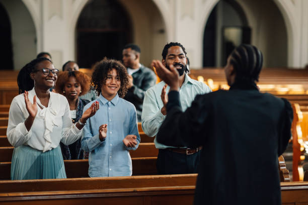 istock Congregation clapping along with preacher in church 2176799559