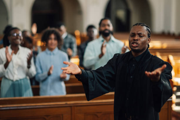 istock African american priest leading congregation in prayer 2176799560