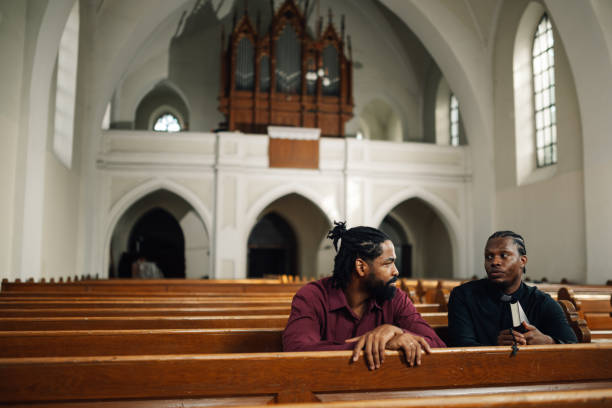 istock Two men having a conversation in church pews 2176799598