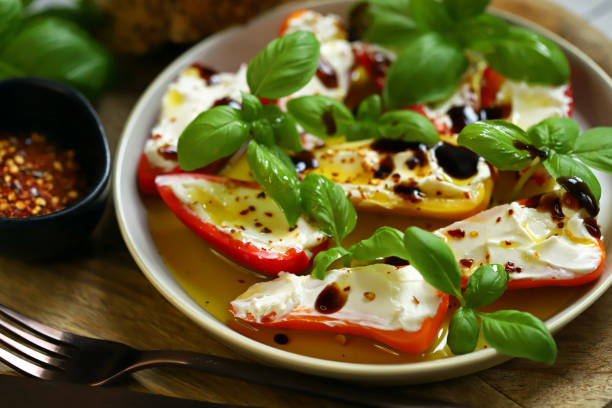 Mini peppers stuffed with cream cheese in olive oil with basil