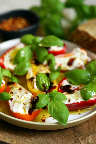 istock Mini peppers stuffed with cream cheese in olive oil with basil 2176815143