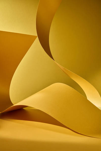 istock The carefully cut paper strips have a wavy shape that creates empty space to display products and text on a copper-yellow background, giving the impression of luxury. 2176831349