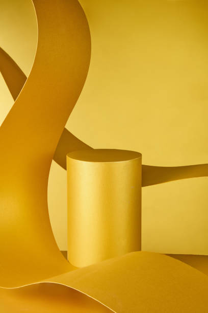 istock A sophisticated product display with an exquisite appearance may be achieved with this eye-catching arrangement that combines a yellow paper platform with a graceful ribbon paper. 2176831553