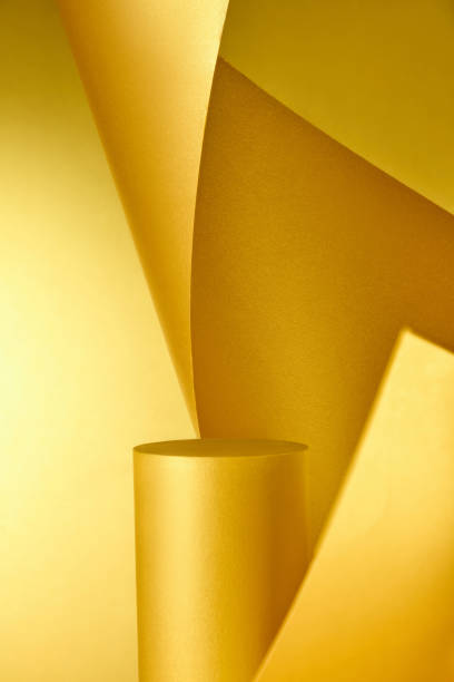 istock An creative arrangement for product placement is created by a delicate yellow paper sheet contrasting with a yellow backdrop and a cylindrical platform made of yellow cardboard. 2176831646