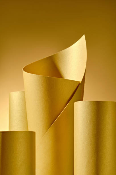 istock The image features yellow paper cylinders, one gracefully curved and extending forward, creating a dramatic focal point, while a soft background highlights empty space and showcases products. 2176831866