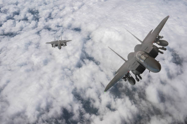 istock F-15 jet aircraft flying over clouds. 2176846267