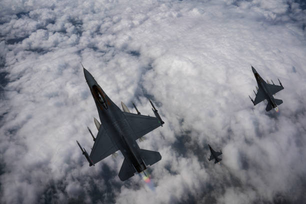 istock F-35 jet aircraft flying over clouds. 2176846931
