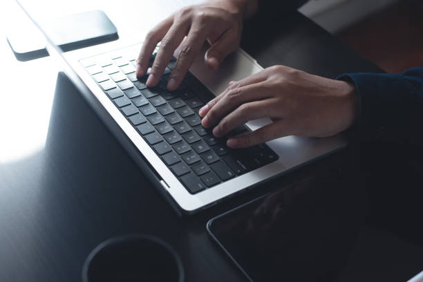 istock Business man hands typing on laptop computer keyboard, searching information, surfing the internet on dark office desk, distance job, online working, business and technology concept 2176858172