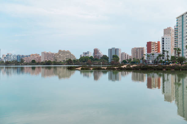 istock Cityscape with modern buildings reflected in calm water 2176861380