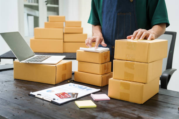 istock A man is working at his desk, preparing parcel boxes for shipment. He checks and packs items carefully, using shockproof materials, and attaches labels before sending them to customers via EMS. 2176862171