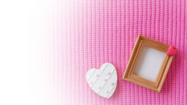 istock White Heart Shaped Gingerbread Cookie on a Woolen Background and Wooden Empty Frame. Valentine Mothers Day Concept. Love Background. Vintage Retro Gradient Effect Photo 2176865154