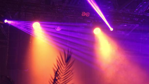 Raised silhouetted hands and beacon of light